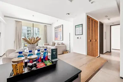 a living room with a table with drinks on it at Large 2BR with Work Desk, Pool, Gym and Kids Area in Dubai