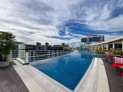 a large swimming pool on top of a building at Palm Jumeirah - Luxe Infinity Pool I Direct Beach Access in Dubai