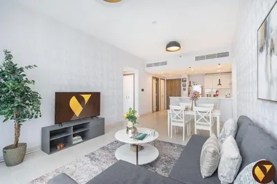 a living room with a couch and a tv at Vogue Al Wasl 1 Residences Near Zabeel Park and World Trade Centre, Two Bedroom Apartment with Balcony and Dubai Frame, Access to all Amenities, Walkable to Max Fashion Metro Station in Dubai
