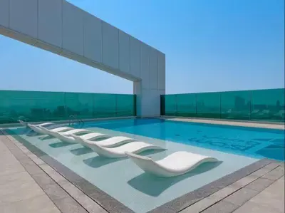 a swimming pool with a row of white lounge chairs at Vogue Al Wasl 1 Residences Near Zabeel Park and World Trade Centre, Two Bedroom Apartment with Balcony and Dubai Frame, Access to all Amenities, Walkable to Max Fashion Metro Station in Dubai