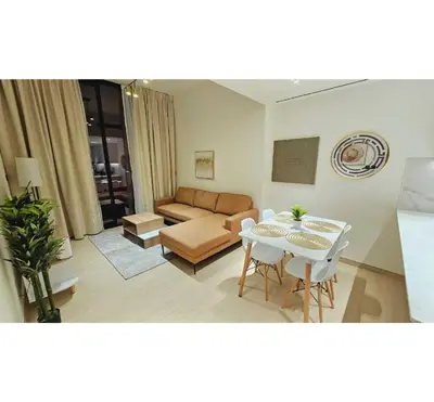 a living room with a couch and a table at Spacious 1BR Apartment in Binghatti Emerald JVC in Dubai