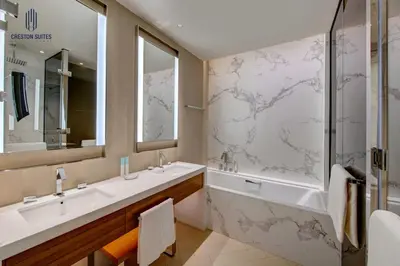 a bathroom with two sinks and a large shower at Luxury 1-BR at Dubai Opera Stay in Dubai