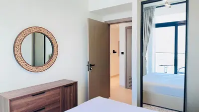 a bedroom with a mirror and a bed at Premium 1 Bed Apartment In Binghatti Venus in Dubai