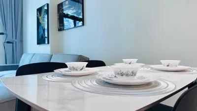 a table with four cups and saucers on it at OYO HOME 1457 Premium 1bed Apartment In Jvc Bh in Dubai