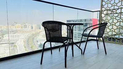two black chairs sitting on top of a balcony at OYO HOME 1457 Premium 1bed Apartment In Jvc Bh in Dubai