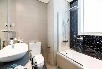 a bathroom with a sink and a toilet and a shower at OYO HOME 1458 Premium 1bed Apartment In Jvc Be1005 in Dubai