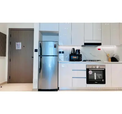 a kitchen with a stainless steel refrigerator and a stove at OYO HOME 1458 Premium 1bed Apartment In Jvc Be1005 in Dubai