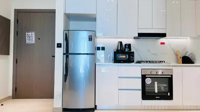 a kitchen with a stainless steel refrigerator and a stove at OYO HOME 1458 Premium 1bed Apartment In Jvc Be1005 in Dubai