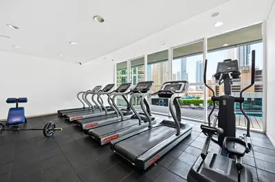 a row of cardio machines in a gym at Serene Escape in Bustling Marina and JBR, Ensuite 2BR, Sky Garden Access in Dubai