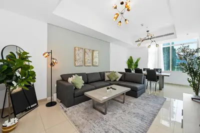 a living room with a couch and a table at Serene Escape in Bustling Marina and JBR, Ensuite 2BR, Sky Garden Access in Dubai