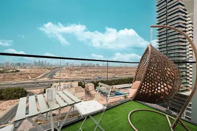 a view of a city from the balcony of a building at Cozy 1 BR with gym & pool just 15min to Dubai Marina in Dubai