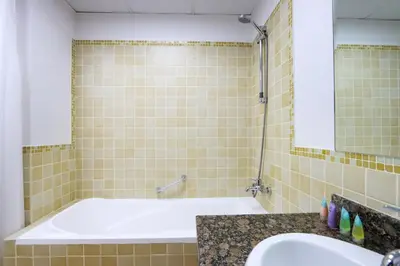 a bathroom with a tub and a sink at Livbnb - Scenic 2BHK with Amazing Marina Views in Dubai