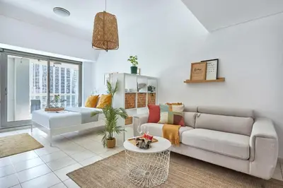 a living room with a couch and a table at Frank Porter - Lake Terrace Tower in Dubai