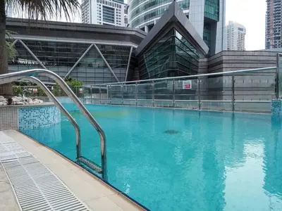 a swimming pool in a city with tall buildings at Frank Porter - Lake Terrace Tower in Dubai