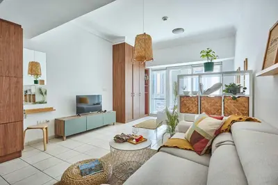 a living room with a couch and a tv at Frank Porter - Lake Terrace Tower in Dubai