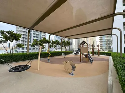 a play area with a playground with a slide at Coastal Elegance 1-Bedroom in Grand Bleu in Dubai