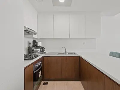 a kitchen with a sink and a counter top at Spacious and Cozy 1BDR in Hameni in Dubai