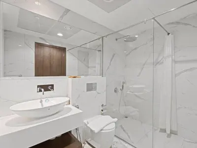 a bathroom with a sink and a toilet and a shower at Spacious and Cozy 1BDR in Hameni in Dubai