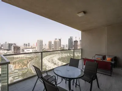 a room with a table and chairs and a large window at Spacious and Cozy 1BDR in Hameni in Dubai