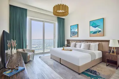 a bedroom with a large bed and a large window at Frank Porter - Palm View in Dubai