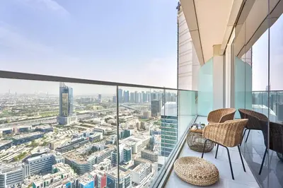 a balcony with chairs and a view of a city at Frank Porter - Palm View in Dubai