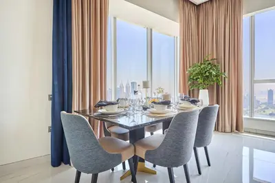 a dining room with a table and chairs at Frank Porter - Palm View in Dubai