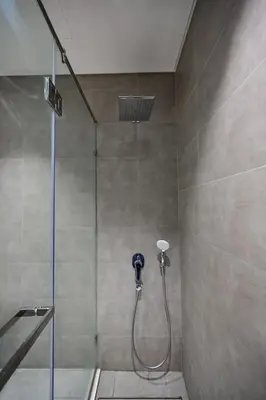a shower in a bathroom with a glass door at Stunning 1 Bdr Luxury District one in Dubai