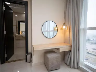 a bathroom with a vanity and a mirror at Court Tower in Dubai