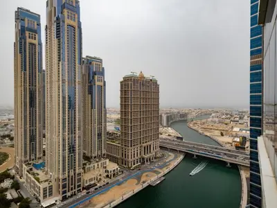 an aerial view of a city with tall buildings and a river at Court Tower in Dubai