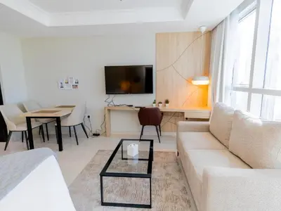 a living room with a couch and a table at Court Tower in Dubai
