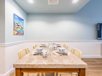 a dining room with a table and chairs at Stylish 1-Bedroom with Panoramic Partial Sea View in Dubai
