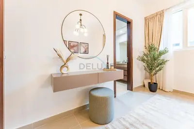 a dressing room with a vanity and a mirror at City View 2BR Just Steps from the Mall, Roxana Residence B, Jumeirah Village Circle by Deluxe Holiday Homes in Dubai