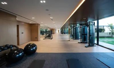 a gym with exercise equipment in a building at Stylish 1br In Jvc Balcony, Pool & Free Parking in Dubai