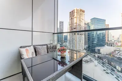 a glass balcony with a view of a city at Dubai Canal and City Views 1BR, Minutes Drive to Burj Khalifa, DAMAC Zada Tower, Business Bay by Deluxe Holiday Homes in Dubai