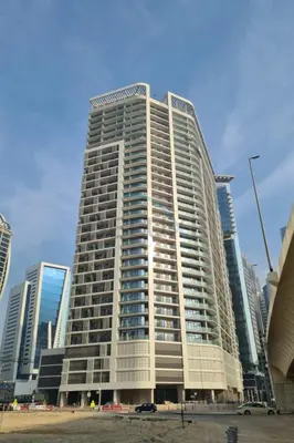 a tall building in front of a city at Dubai Canal and City Views 1BR, Minutes Drive to Burj Khalifa, DAMAC Zada Tower, Business Bay by Deluxe Holiday Homes in Dubai