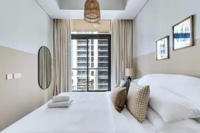 a bedroom with a large white bed with a window at GuestReady - Elegant city escape in Business Bay in Dubai