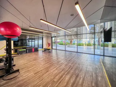 an empty office with a wooden floor and large windows at GuestReady - Elegant city escape in Business Bay in Dubai