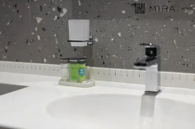 a bathroom sink with a soap dispenser on it at Mira Holiday Homes - Newly and modern 1 bedroom with lake view in JLT in Dubai