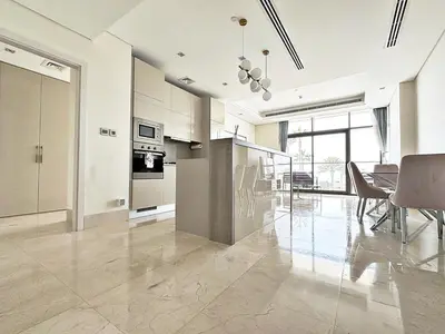 a kitchen and dining room with a table and chairs at AURA -Direct Seafront 2BR-Palm in Dubai