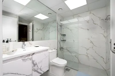 a bathroom with a toilet and a sink and a shower at Serene Getaway in Dubai