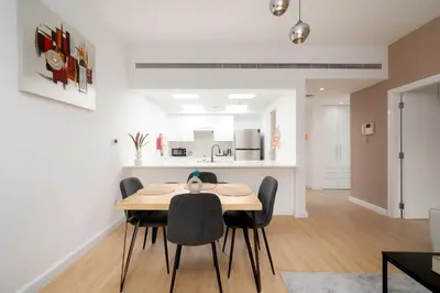 a dining room and kitchen with a table and chairs at Serene Getaway in Dubai