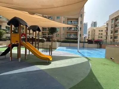 a playground with a slide next to a building at Serene Getaway in Dubai