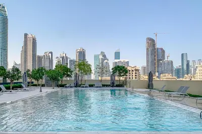 a swimming pool with a city skyline in the background at Frank Porter - Burj Royale in Dubai