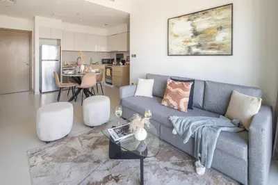 a living room with a couch and a table at Frank Porter - Burj Royale in Dubai