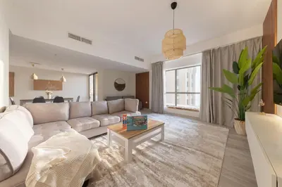 a living room with a white couch and a table at Luxe 2BR Dubai Retreat with Ain Dubai View for 6 guests in Dubai