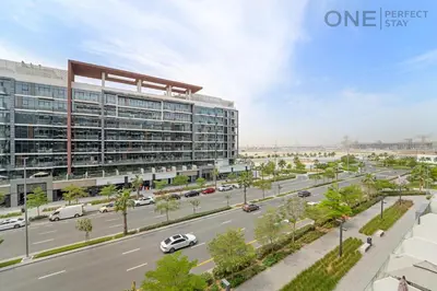 an architectural rendering of a large building with a street at Cozy Studio Apartment in Meydan in Dubai