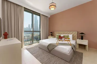 a bedroom with a bed and a large window at Elite Escape - 3 BHK Burj View & Dubai Mall Access in Dubai