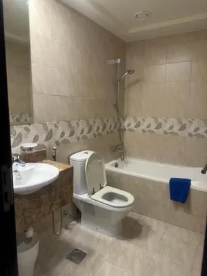 a bathroom with a toilet and a sink and a tub at RKOkeys in Dubai
