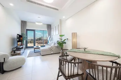 a living room with a table and chairs and a couch at Urban 1BR City view in The Bay Business Bay in Dubai