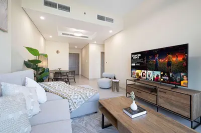 a living room with a large flat screen tv at Urban 1BR City view in The Bay Business Bay in Dubai